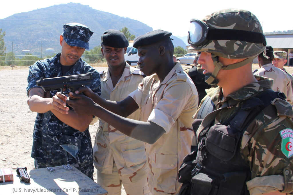 170509-N-NS419-001 

CARTAGENA, Spain (May 9, 2017) Hospital Corpsman 2nd Class Darren Williams, a U.S. Navy Reservist assigned to Navy Operational Support Center Denver, assists Mauritanian and Algerian sailors with a non-lethal weapons training demonstration during exercise Phoenix Express 2017. The exercise is sponsored by U.S. Africa Command and facilitated by U.S. Naval Forces Europe-Africa/U.S. 6th Fleet, and designed to improve regional cooperation, increase maritime domain awareness information-sharing practices, and operational capabilities to enhance efforts to achieve safety and security in the Mediterranean Sea. (U.S. Navy photo by Lt. Carl P. Zeilman/Released)